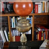 DL36. Converted oil lamp with glass globe shade. 
